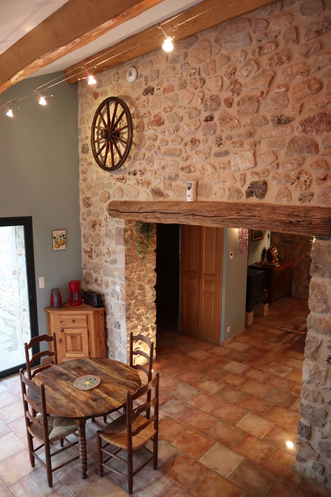 Stone archway between living room and kitchen, rustic decor, Le Rouge Gorge gîte